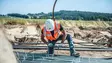  Bauer Resources employee lays pipes for geothermal probes in new Schrobenhausen housing development